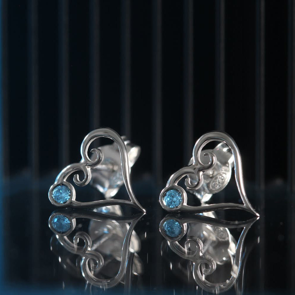 Aqua Kokoro stud earrings in sterling silver with heart shape and natural aquamarine detail