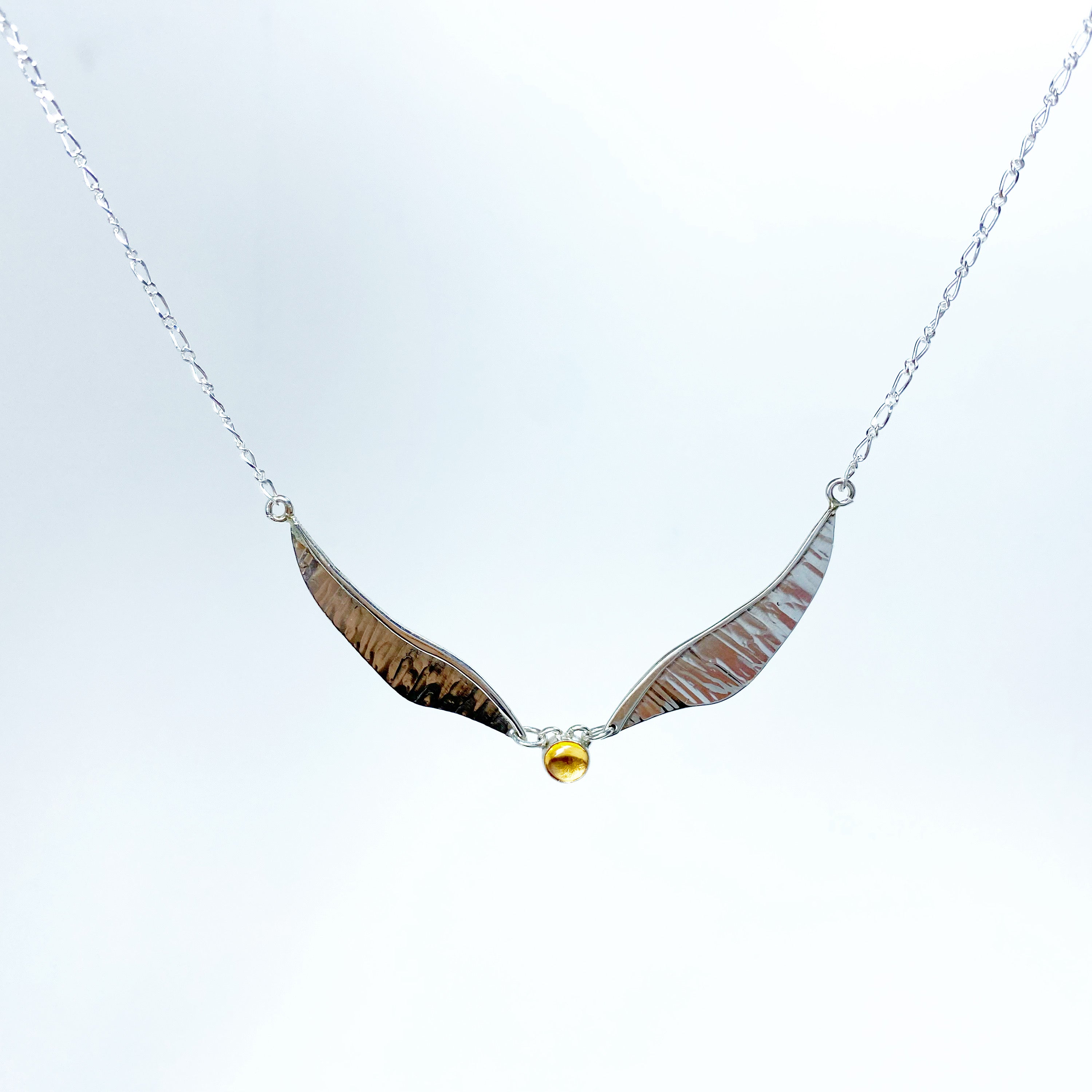 Winged pendant detail with golden citrine and moving structure