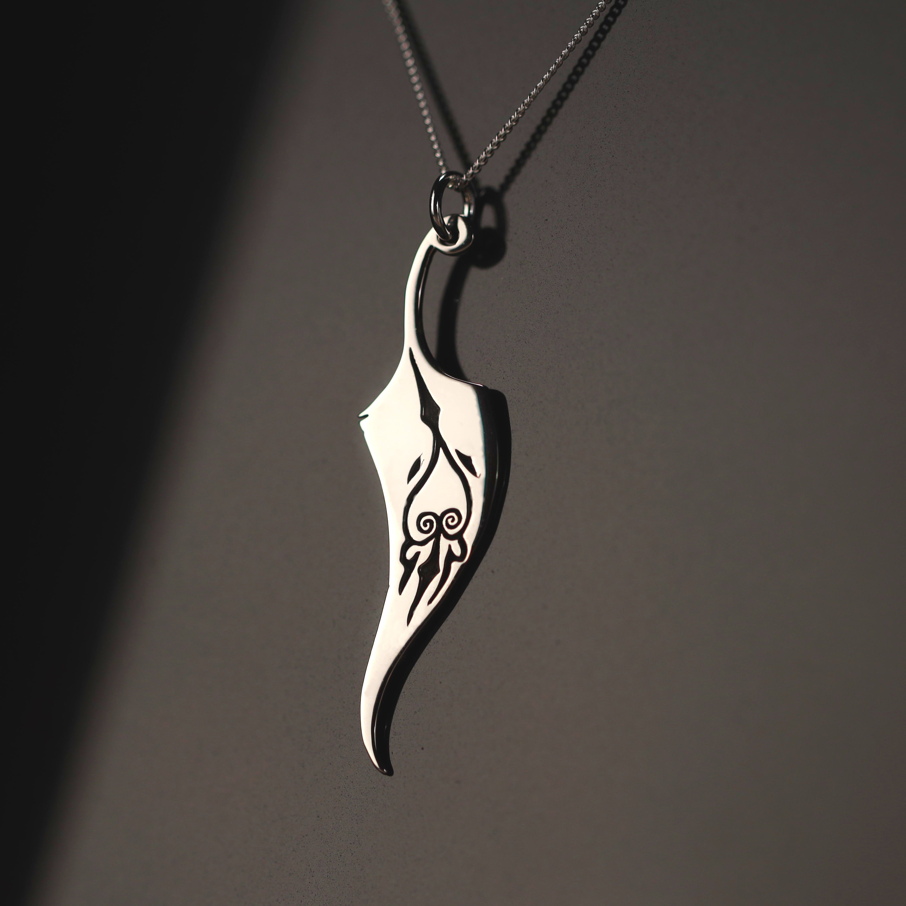 Sterling silver feather necklace with engraved symbol