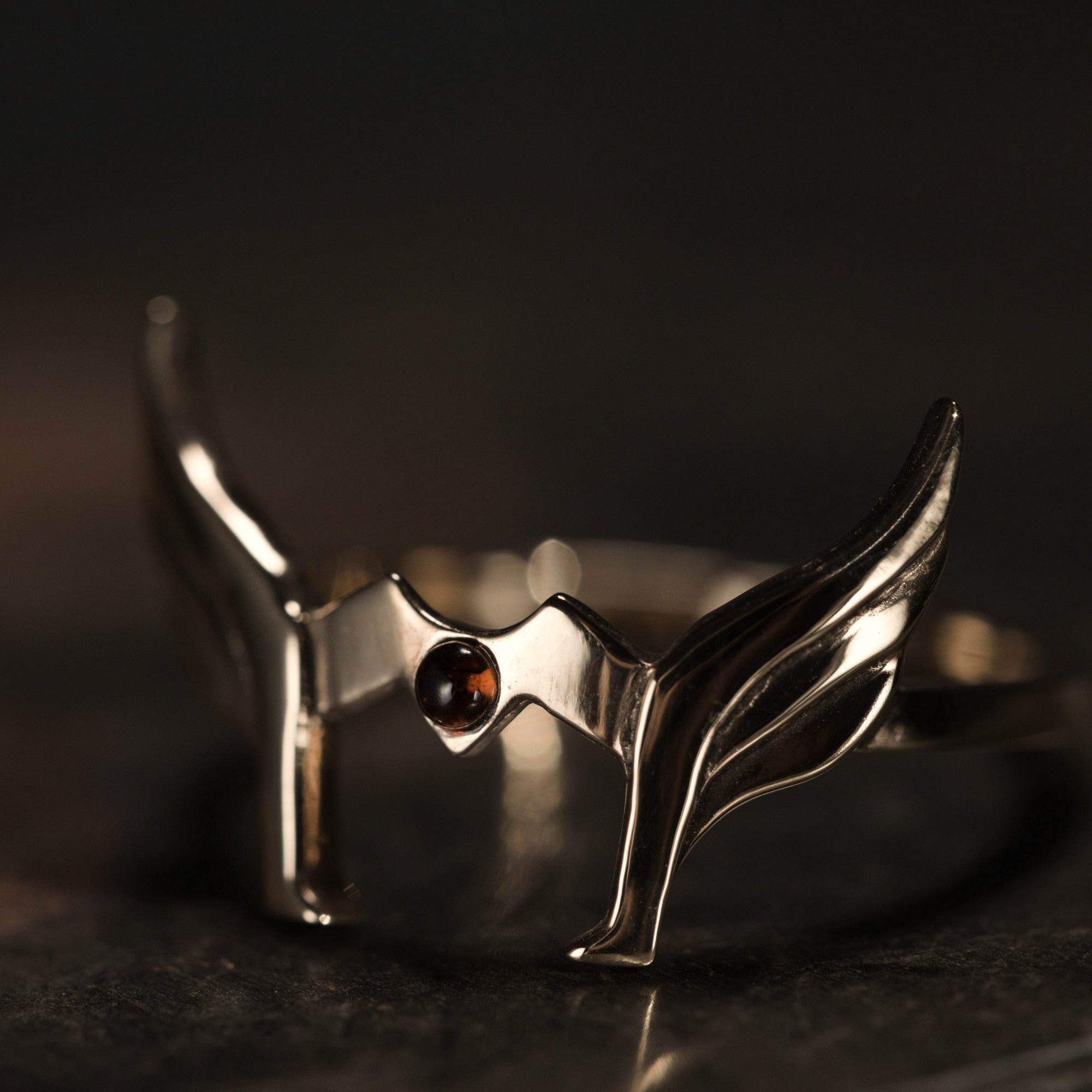 Detail of Helmet ring showing gold plated finish and garnet stone