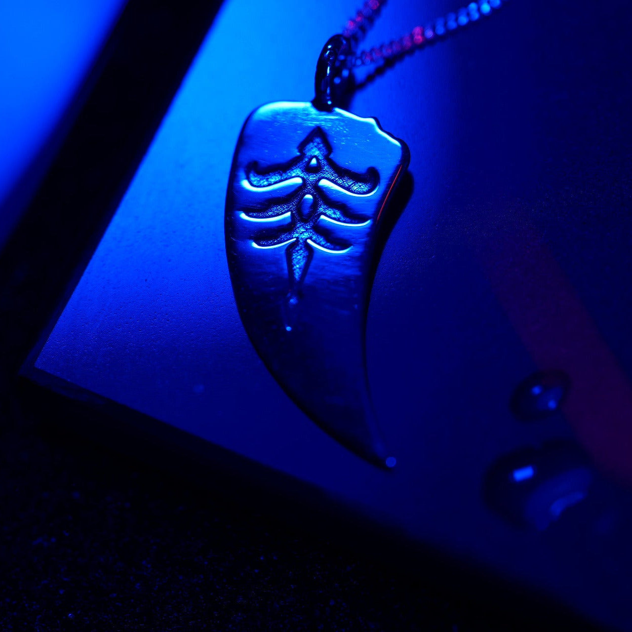 Detail of engraved hunter symbol pendant