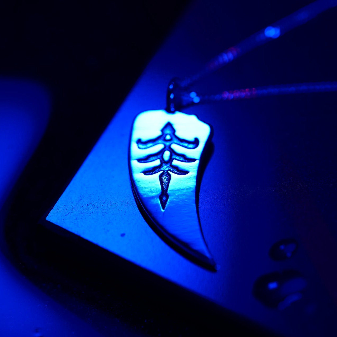 Close-up of hunter sigil necklace in sterling silver
