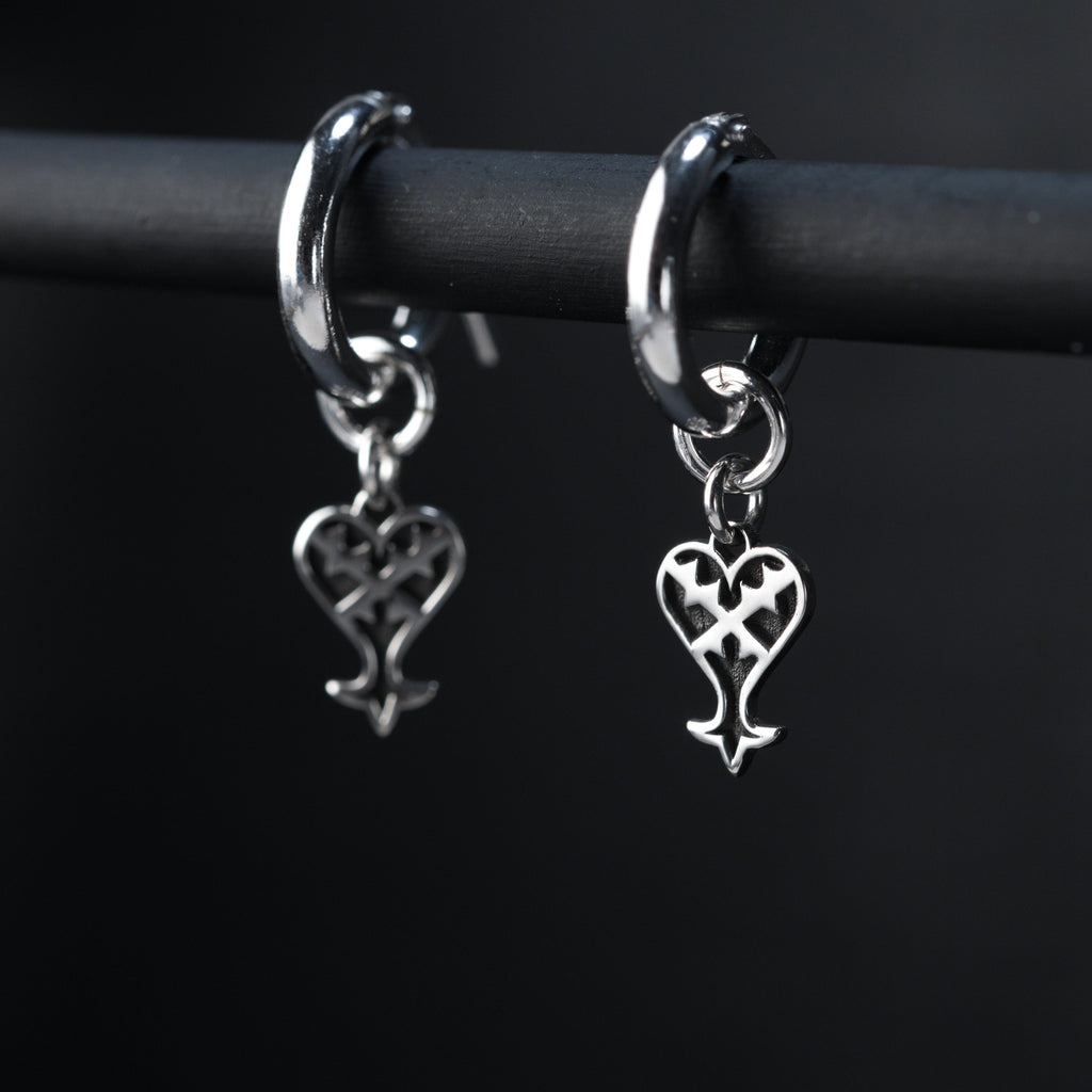 Kage hoop earrings worn, showing subtle and dark inverted heart design