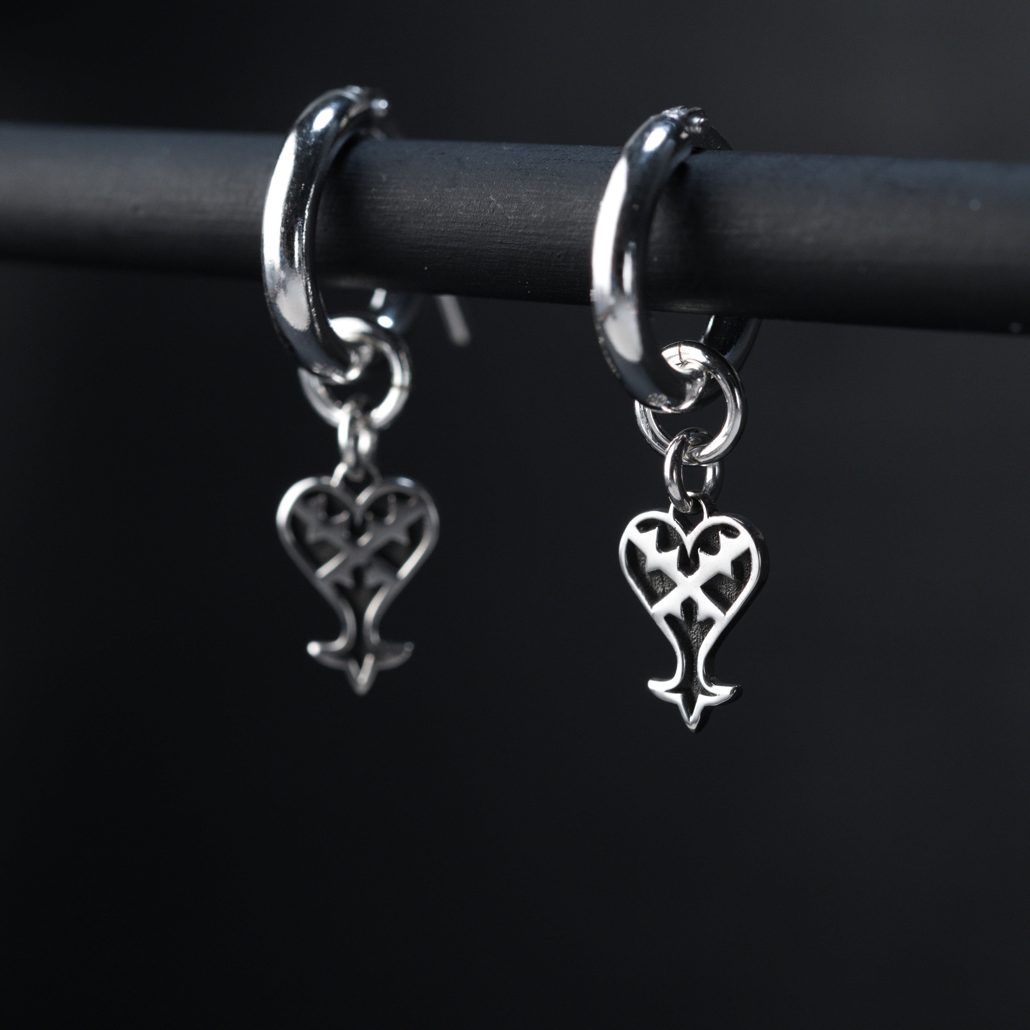 Kage hoop earrings worn, showing subtle and dark inverted heart design