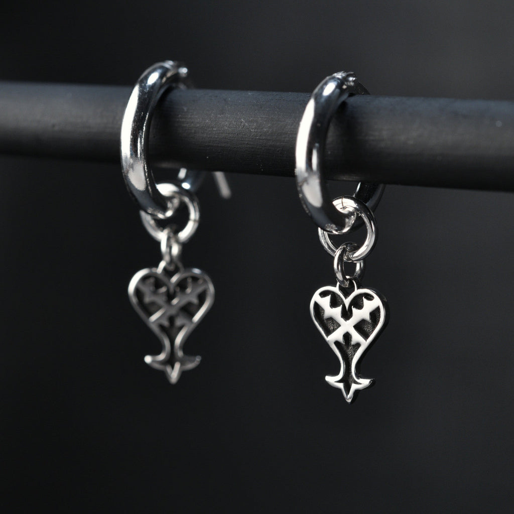 Kage hoop earrings in sterling silver with inverted heart symbol representing darkness