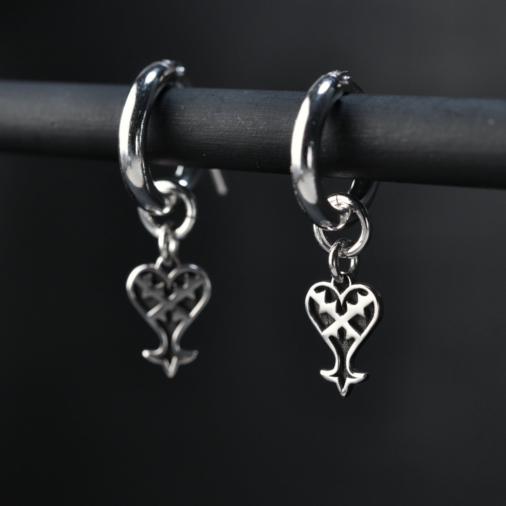 Kage hoop earrings in sterling silver with inverted heart symbol representing darkness