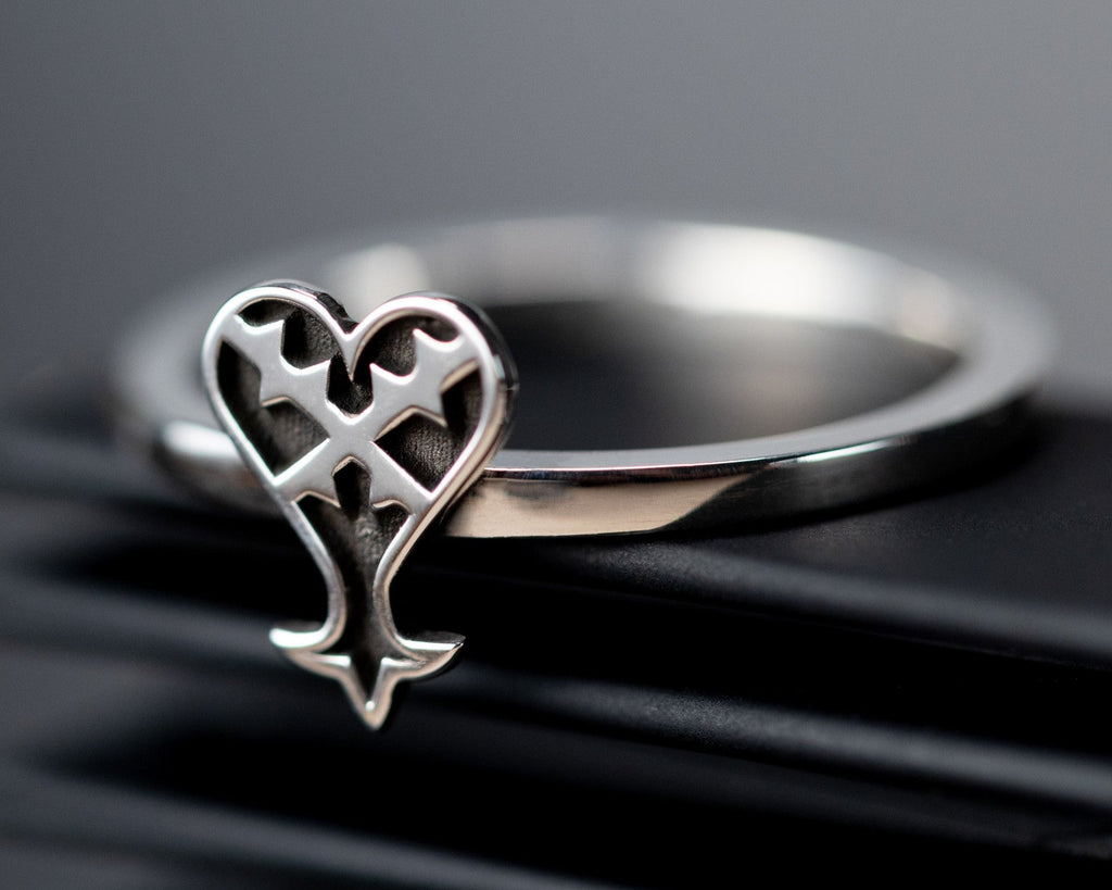 Kage ring in sterling silver with inverted heart symbol representing darkness