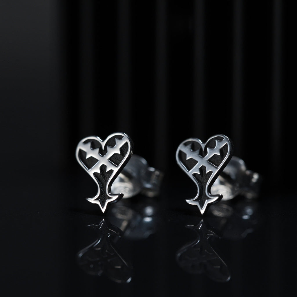 Detail of Kage stud earrings showing inverted heart design in sterling silver