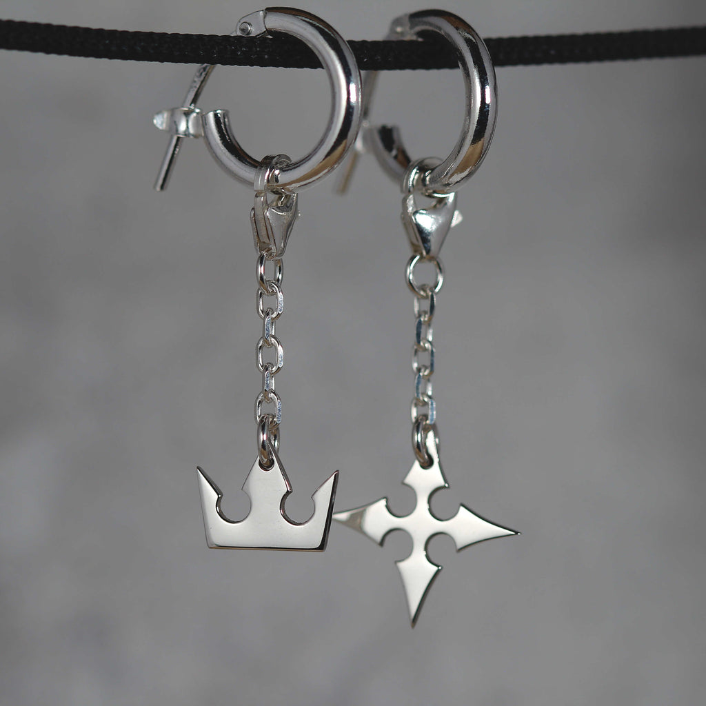 Korona chain earrings worn, showing movement and elegant chain connection between hoop and charms