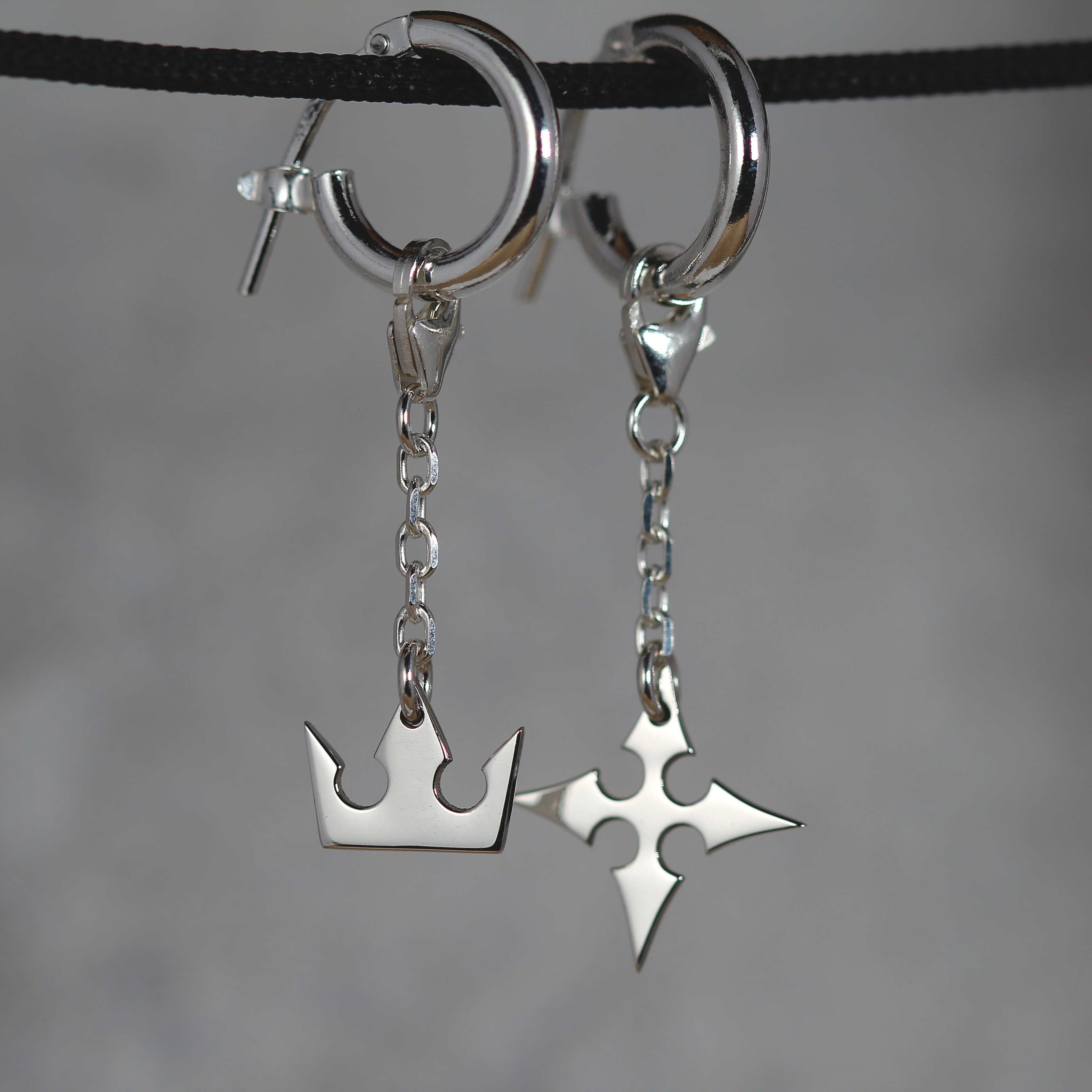 Korona chain earrings worn, showing movement and elegant chain connection between hoop and charms