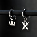 Korona hoop earrings in sterling silver with crown and cross symbols representing light and darkness
