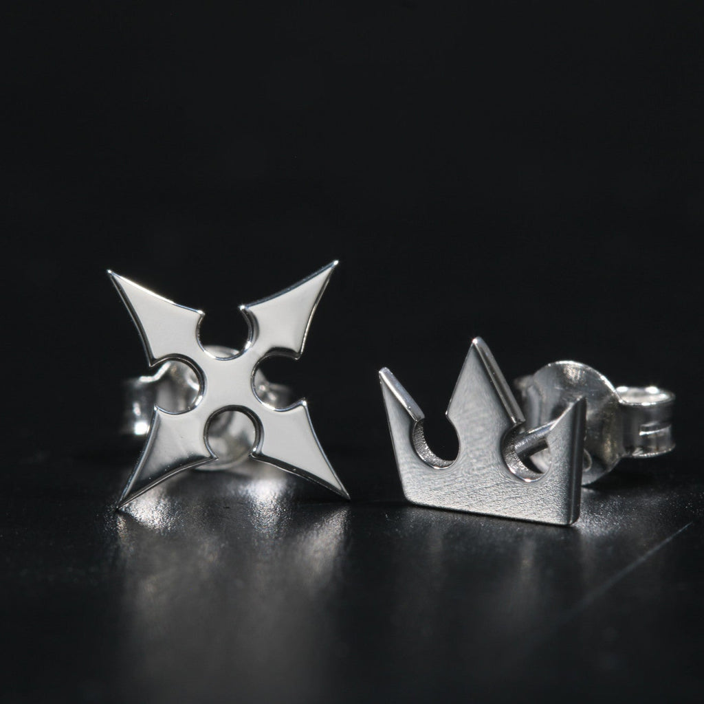 Korona stud earrings worn, showing subtle and elegant crown and cross design
