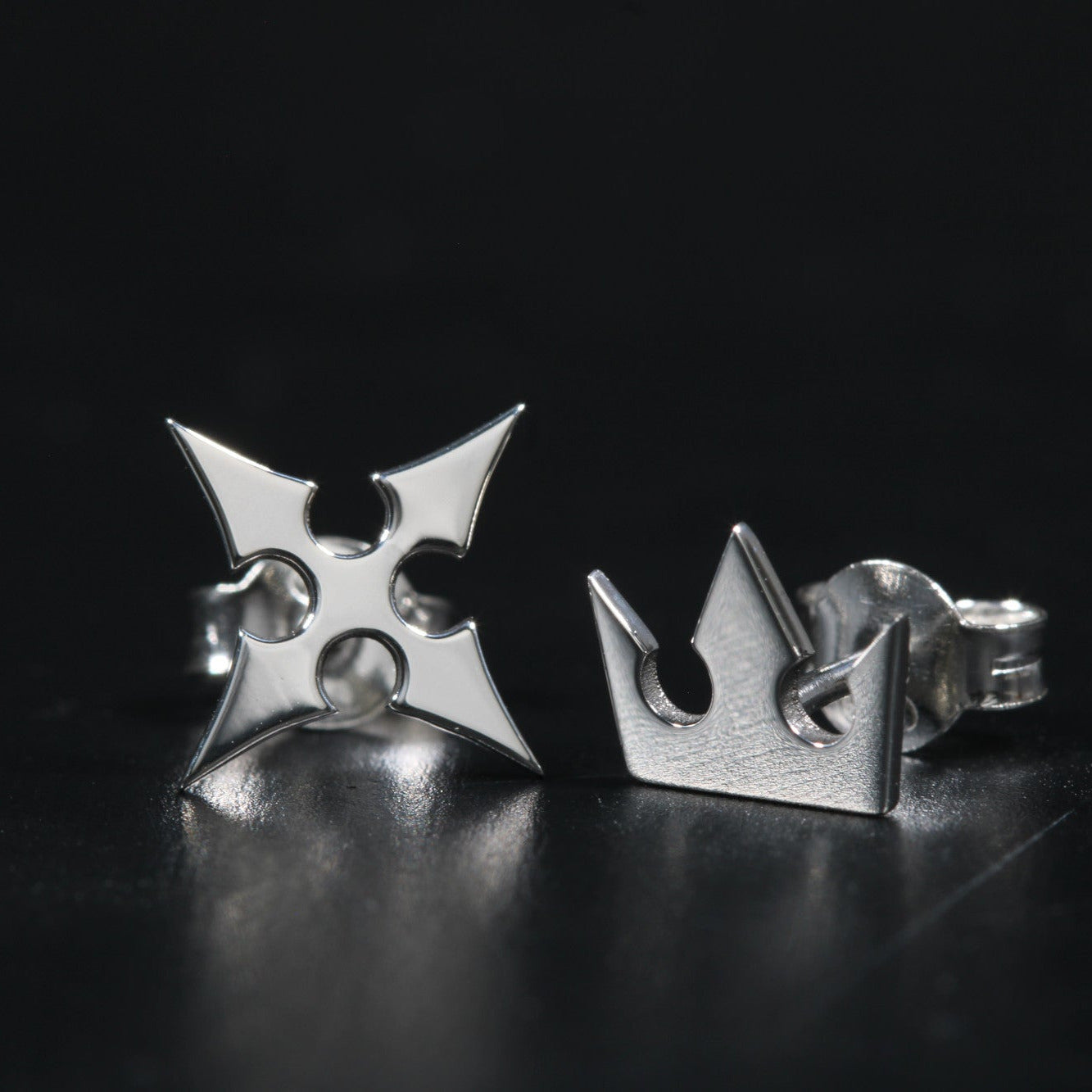 Korona stud earrings worn, showing subtle and elegant crown and cross design