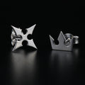 Korona stud earrings in sterling silver with crown and cross symbols representing light and darkness