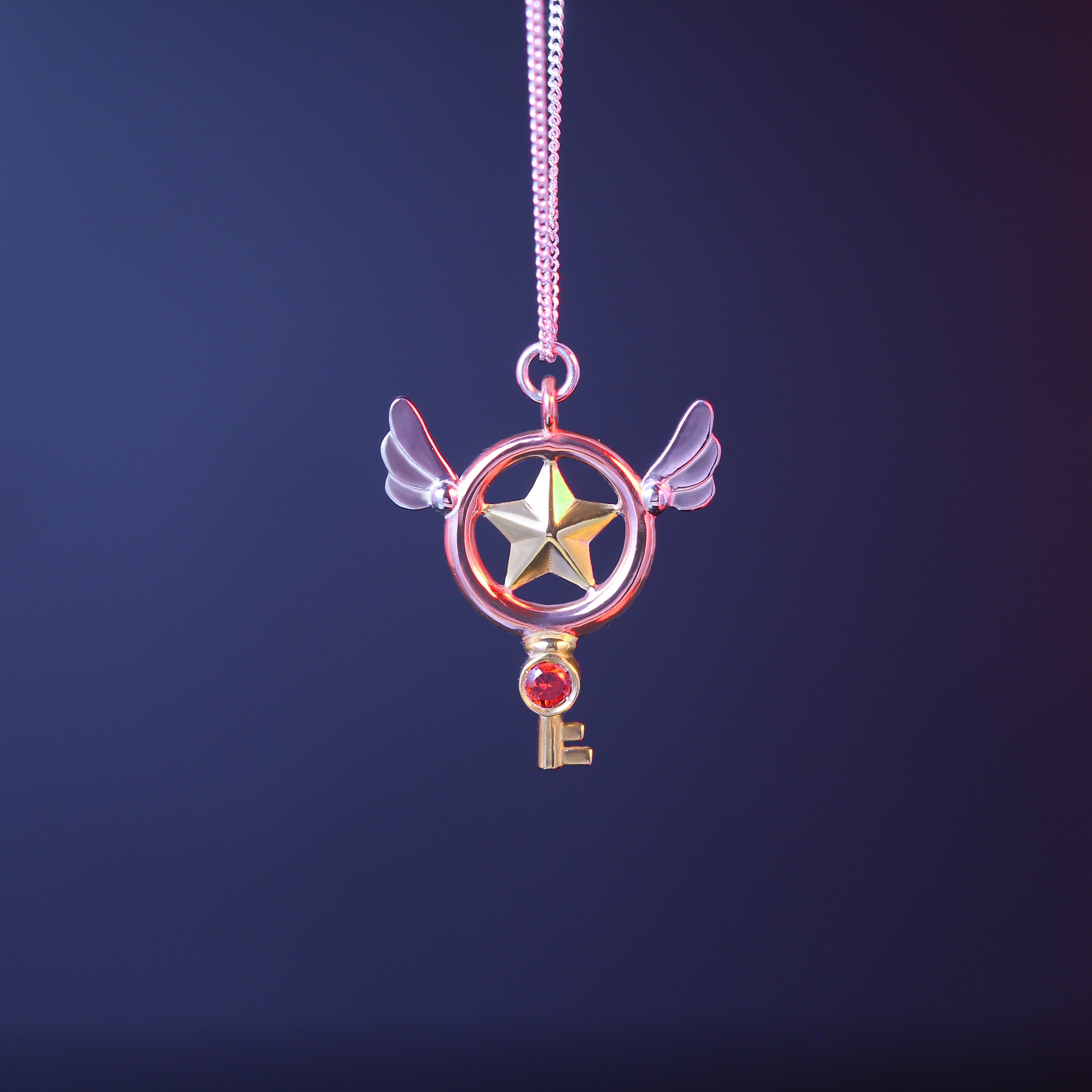 Sterling silver magical key necklace with garnet and gold-plated details