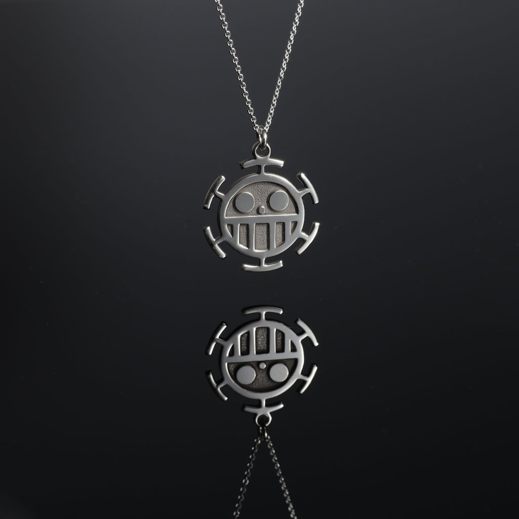 Detail and reflection of a sterling silver sea emblem necklace