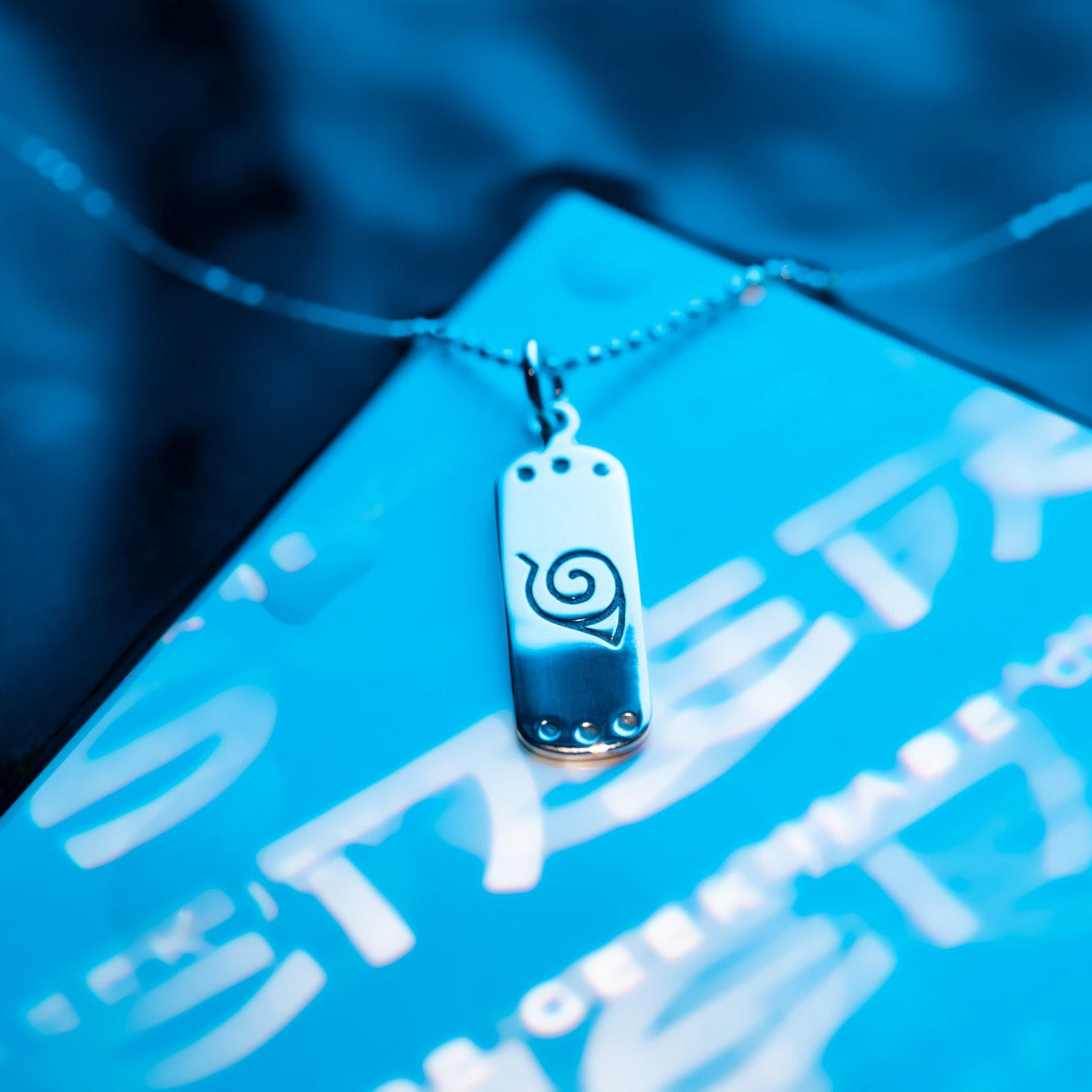 Detail of engraved village symbol in sterling silver