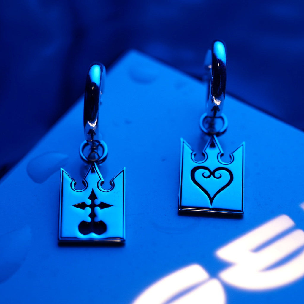 Detail of Unmei earrings showing engraved symbols on sterling silver cards