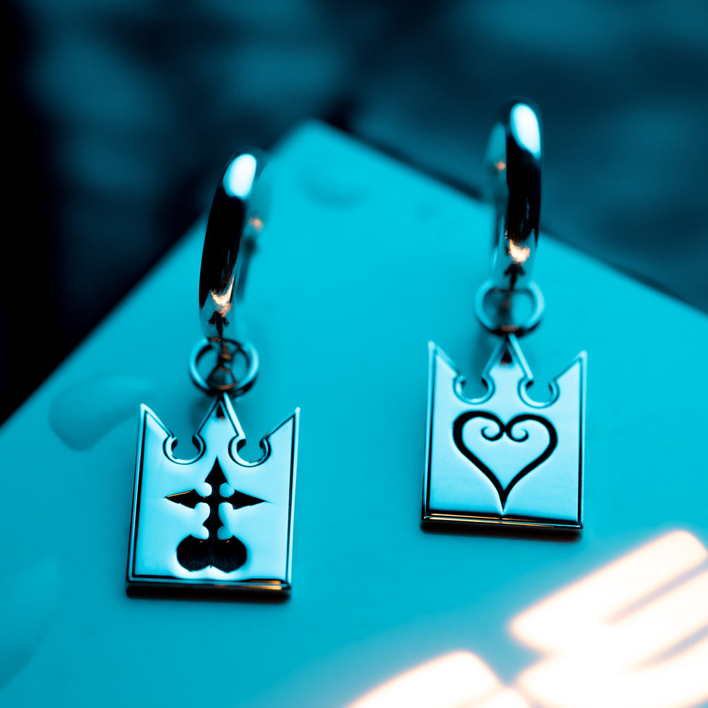 Full view of Unmei earrings in sterling silver with card design and engraved heart and incorporeal symbols