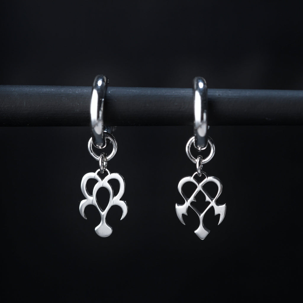Yume hoop earrings in sterling silver with dream and nightmare symbols, rounded and sharp shapes