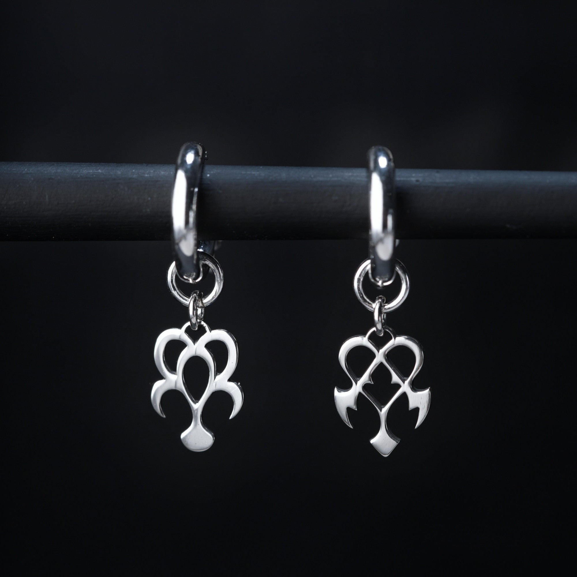 Yume hoop earrings in sterling silver with dream and nightmare symbols, rounded and sharp shapes